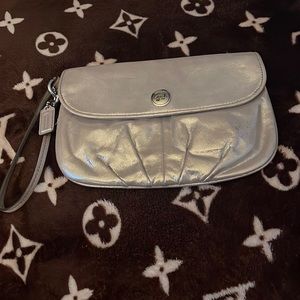 COACH metallic gold wristlet in good condition. Dimensions are 9’width 6’ length